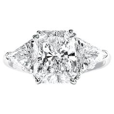 a three stone diamond ring set in 18k white gold