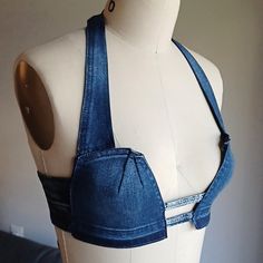 a female mannequin wearing a blue jean bra with an open back and straps