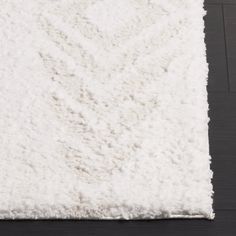 a white area rug on the floor