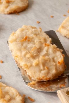 some cookies are on a spoon and scattered with orange zested sugar, ready to be eaten