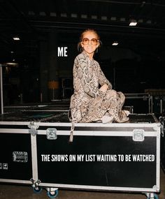 a woman sitting on top of a trunk with the words me in front of her