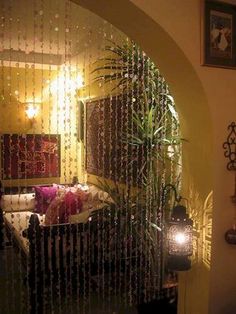 a room with a bed, mirror and lights on the wall in front of it