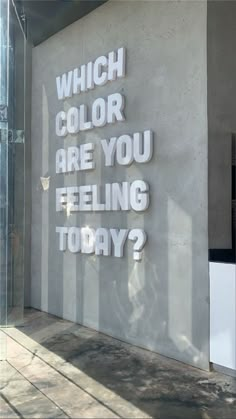 a sign on the side of a building that says which color are you feeling today?