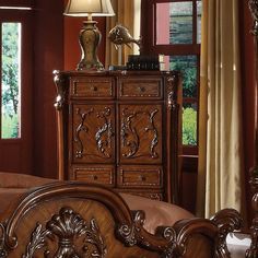 an ornate wooden bed frame with drawers and headboard is shown in front of a window