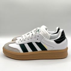 Elevate your sneaker game with these Adidas Men's Samba Originals in size 7.5. The classic white and green colorway, combined with the iconic three stripes, makes for a stylish and versatile addition to any wardrobe. These sneakers are perfect for both casual and athletic occasions, and are sure to turn heads wherever you go. The Adidas Samba has a comfortable and supportive fit, with a sleek design that will keep you feeling confident and stylish all day long. Whether you're hitting the gym or just running errands, these sneakers are the perfect choice. Don't miss out on this must-have footwear item from one of the world's leading athletic brands. Granola Boy, Fitness Fits, Mens Gym Shoes, Samba Sneakers, Adidas Branding, Adidas Three Stripes, Men's Fitness, Feeling Confident, Athletic Style