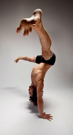 a man doing a handstand on his stomach