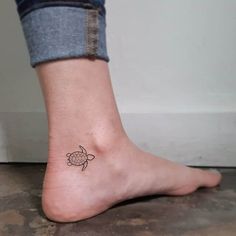 a small turtle tattoo on the ankle