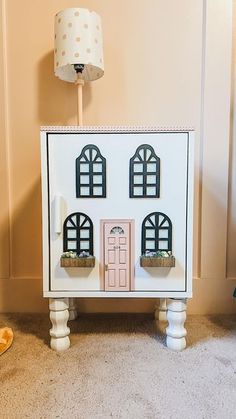 a doll house on top of a small table