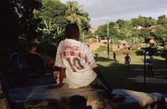 a man sitting on top of a cement bench