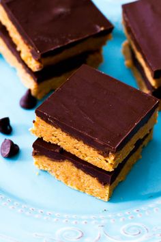 chocolate and peanut butter bars on a blue plate