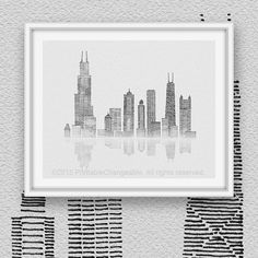 a black and white cityscape with skyscrapers in the background, framed on a wall