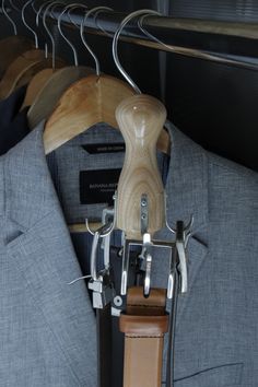 a suit and tie hangers on a rack