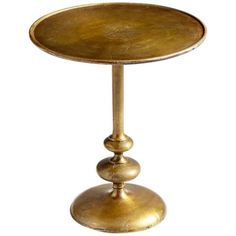 a gold plate with two balls on it sitting on a stand in front of a white background