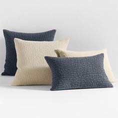 three pillows in various colors and sizes