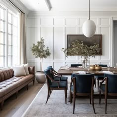 an elegant dining room with blue chairs and white walls