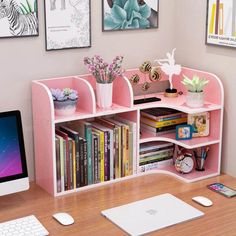 a desk with a computer, keyboard and bookshelf