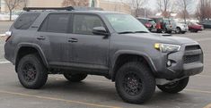 a gray toyota truck parked in a parking lot