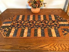 a wooden table topped with a vase filled with flowers