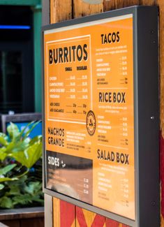 the menu for burritos and tacos is on display