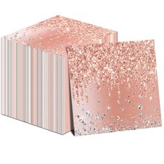 two pink and silver gift boxes with glitter on the top, one is folded in half