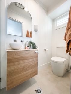 a bathroom with a sink, toilet and mirror