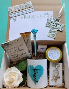 a gift box containing personal items for mother's day, including a mug and keychain