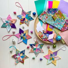 colorful paper stars and ornaments on a plate