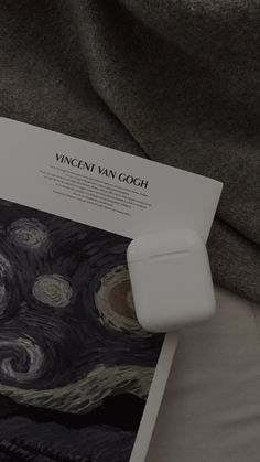 an apple airpods sitting on top of a piece of paper with the word, vincent van gogh