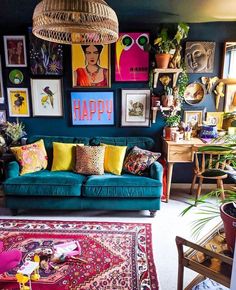 a living room filled with lots of furniture and pictures on the wall next to a rug