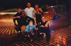 a group of men standing on top of a floor with roller blades in front of them