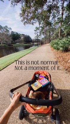 a baby in a stroller with the words this is not normal, not a moment off it