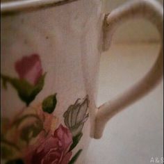 a coffee cup with flowers painted on it