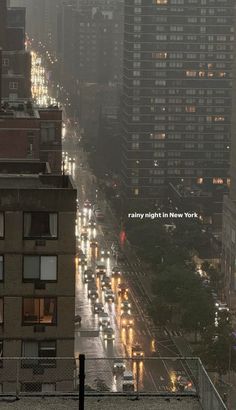 a city street filled with lots of traffic next to tall buildings and skyscrapers at night