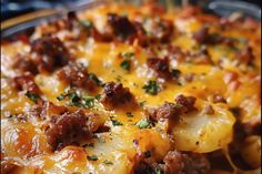 a cheesy casserole dish with meat and potatoes