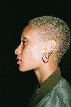 an instagramted photo of a woman with short hair and earrings on her ear