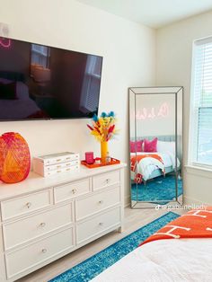 a bedroom with a large flat screen tv on the wall