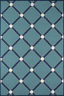 a blue rug with white circles and lines on it's sides, in the shape of an argyle pattern