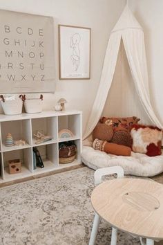 a child's room with a teepee tent and bookshelf