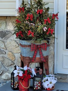 a potted plant with poinsettis and christmas decorations in front of a house