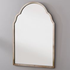 an arched mirror hanging on the wall