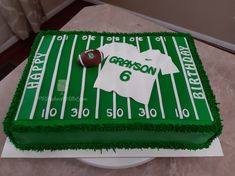 a football field cake with green frosting and white icing on the bottom layer