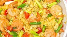 shrimp and vegetable fried rice in a white bowl