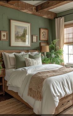 a large bed in a bedroom with green walls and wooden beams on either side of the bed