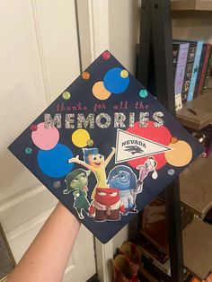 someone is holding up a graduation cap that says memories