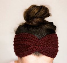 a woman wearing a crochet headband with her hair in a bun