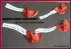 chinese new year craft cupcake liner fortune cookies with red paper bows and writing on them