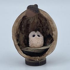 an owl figurine sitting in a paper bag