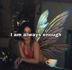 a woman sitting in front of a laptop computer with the words i am always enough