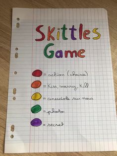 a notebook with skittles game written on it