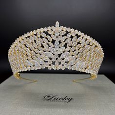 A breathtaking tiara designed in line with elegant royal crowns. Hundreds of perfectly cut high-quality Cubic Zirconia enhance the curvature of this piece. A single solitaire marquise zirconia completes the upper slanted row.  Available on www.ProBridalUSA.com *Handcrafted with highest quality Zirconia jewels and rhodium plated to prevent tarnish and scratch. *High Quality Teardrop, Marquise and Round CZ gems. *Measures 2.875 inches in center  *Ideal for Wedding, Bridal Hair, Anniversary, Quince Wedding Headpiece With Tall Crown Design, Regal Structured Crown Wedding Headpiece, Regal Crown Headpiece For Wedding, Elegant Tall Crown For Party, Regal Wedding Headpiece With Structured Crown, Regal Structured Crown Headpiece For Wedding, Regal Tall Crown Headpieces For Wedding, Regal Tall Crown For Wedding, Gold Princess Crown With Structured Shape